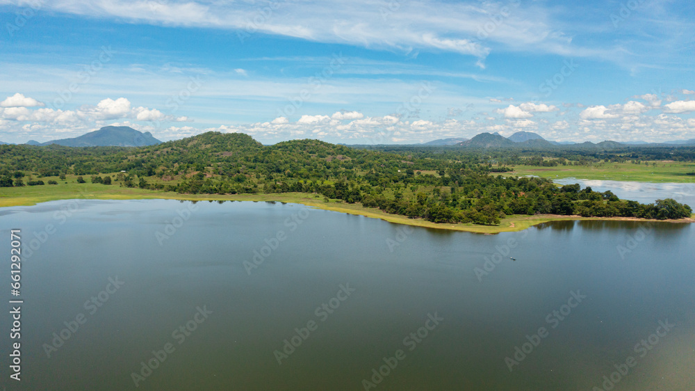 Aerial view of tropical landscape with lake and valley with tropical forest. Sorabora lake, Sri Lanka.