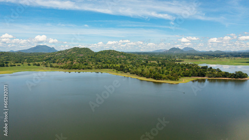 Aerial view of tropical landscape with lake and valley with tropical forest. Sorabora lake, Sri Lanka.