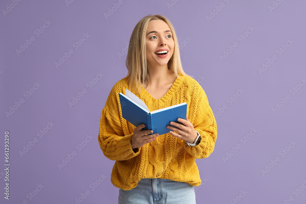 Beautiful young happy woman with book on lilac background Beautiful young happy woman with book on lilac background