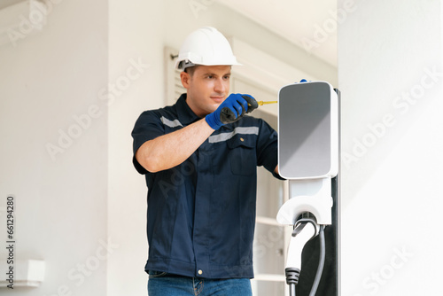 Obraz na plátně Qualified technician install home EV charging station, providing maintenance service for electric vehicle's battery charging platform at home