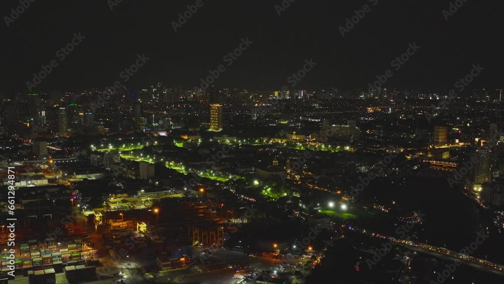 City of Manila with illuminated skyscrapers and seaport at night view from above. City of Manila with illuminated skyscrapers and seaport at night view from above.