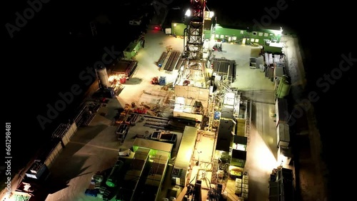 Aerial Of Oil Drilling Rig Illuminated At Night. orbit