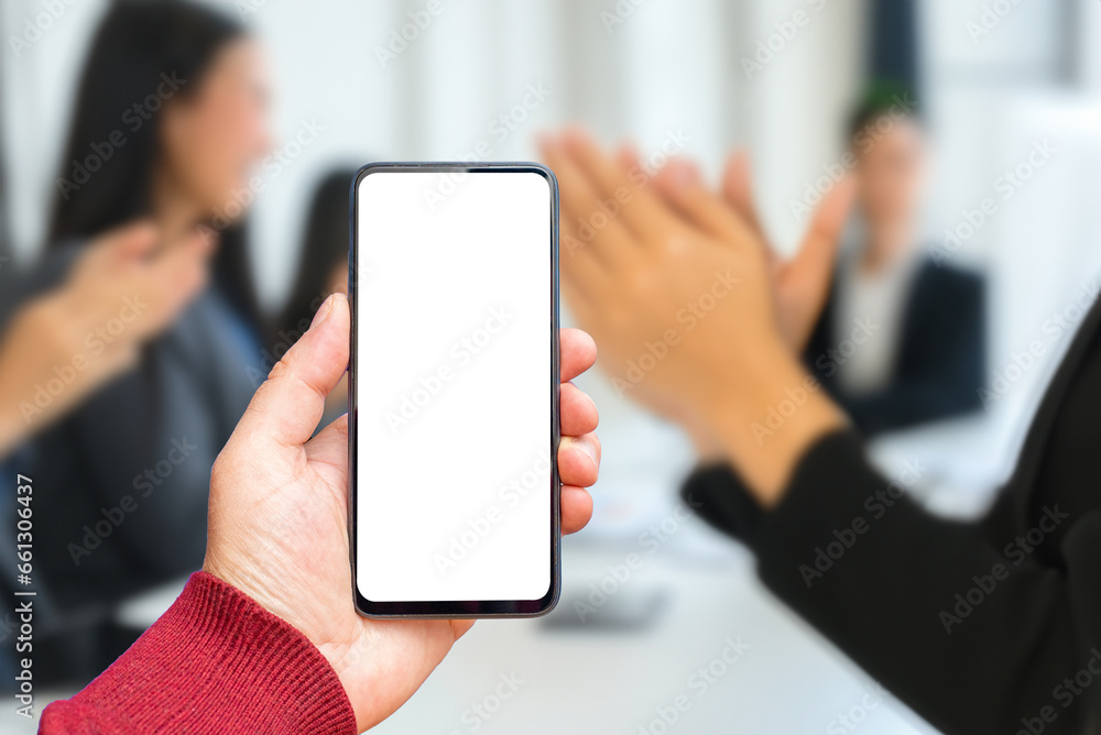 Applause,ovation business office background.Mockup blank white screen of smartphone, male hand holding modern black cellphone with template screen for your logo or design.