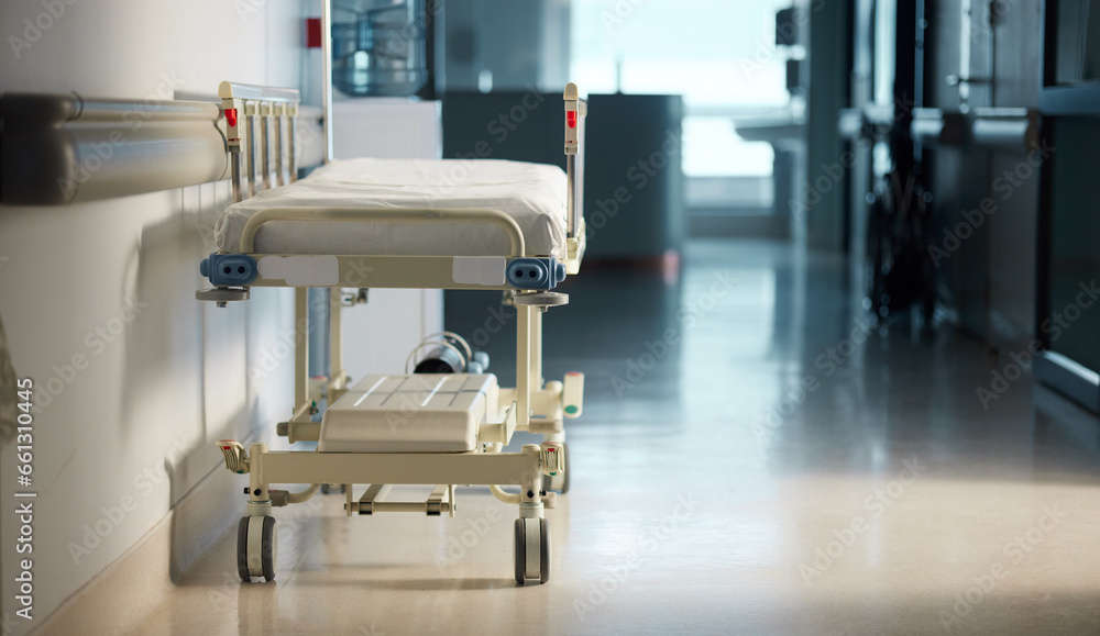 Healthcare, medicine and a bed in the hallway of a hospital after work, ready for an emergency or accident. Medical, wellness and service with a gurney in the empty corridor of a health clinic