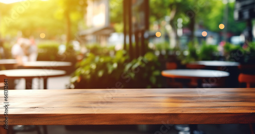 Wooden table with bright blurred background of outdoor cafe restaurant