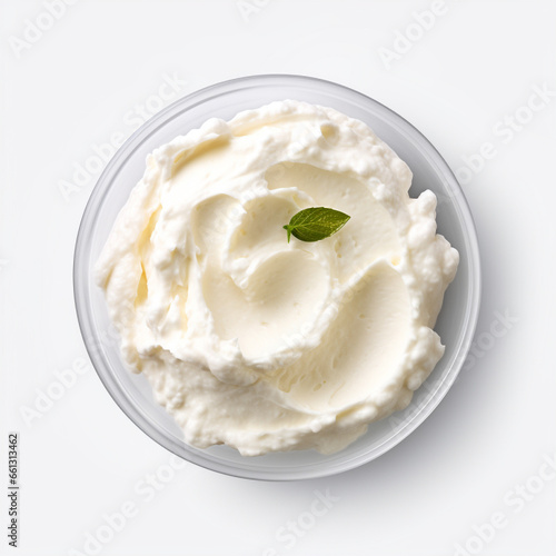 ricotta cheese in a white saucer with a mint leaf, top view