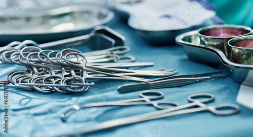 Background, surgery and metal tools in operating room for hospital assessment, healthcare service or emergency in medical theatre. Closeup, surgical equipment and scissors with forceps for operation