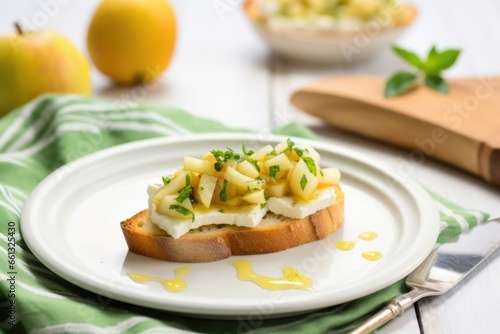 dish with pear bruschetta, napkin, and fork beside
