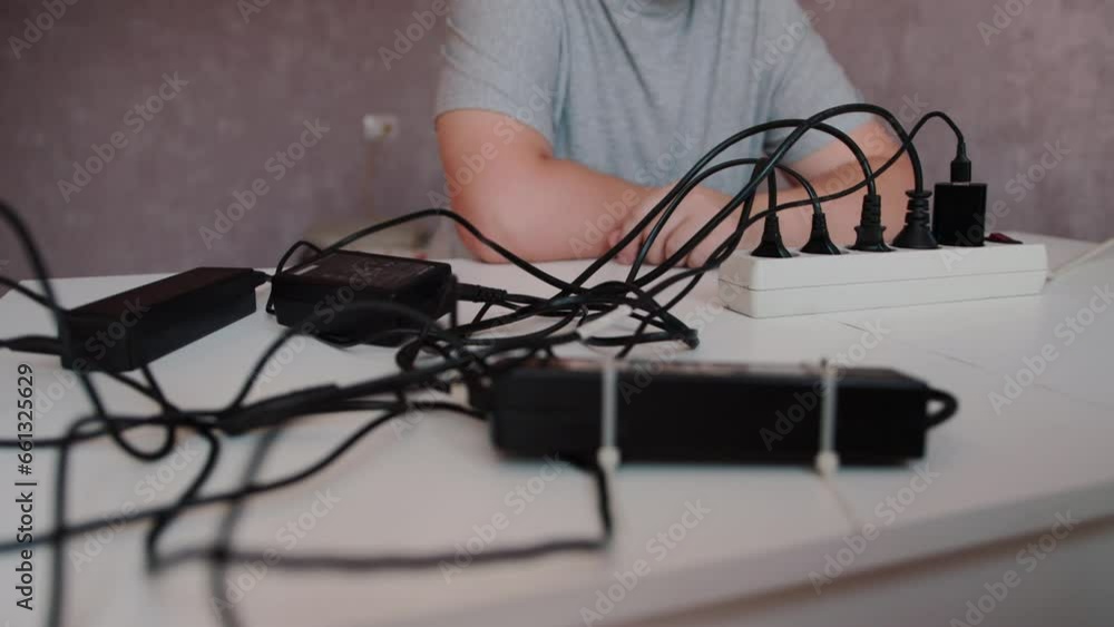 mixed up black electrical wires with electrical plugs in the surge protector. Turning on the button and voltage on the surge protector. Concept of short circuit, fire hazard and electricity. Copy mixed up black electrical wires with electrical plugs in the surge protector. Turning on the button and voltage on the surge protector. Concept of short circuit, fire hazard and electricity. Copy