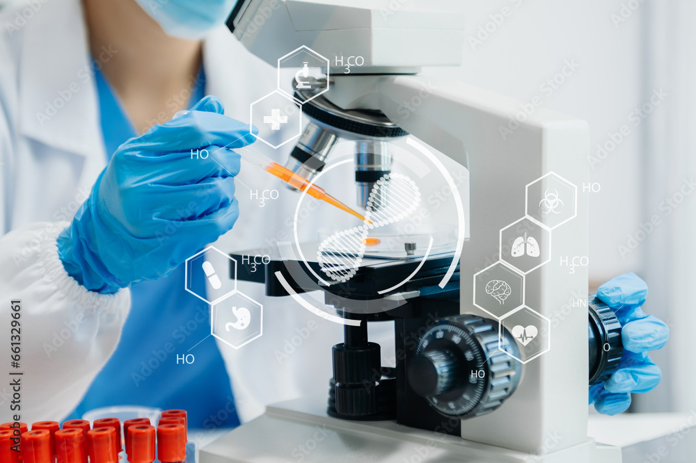 DNA molecule testing concepts. The doctor in a mask examines DNA molecules on the chemical laboratory with virtual icon DNA molecule testing concepts. The doctor in a mask examines DNA molecules on the chemical laboratory with virtual icon
