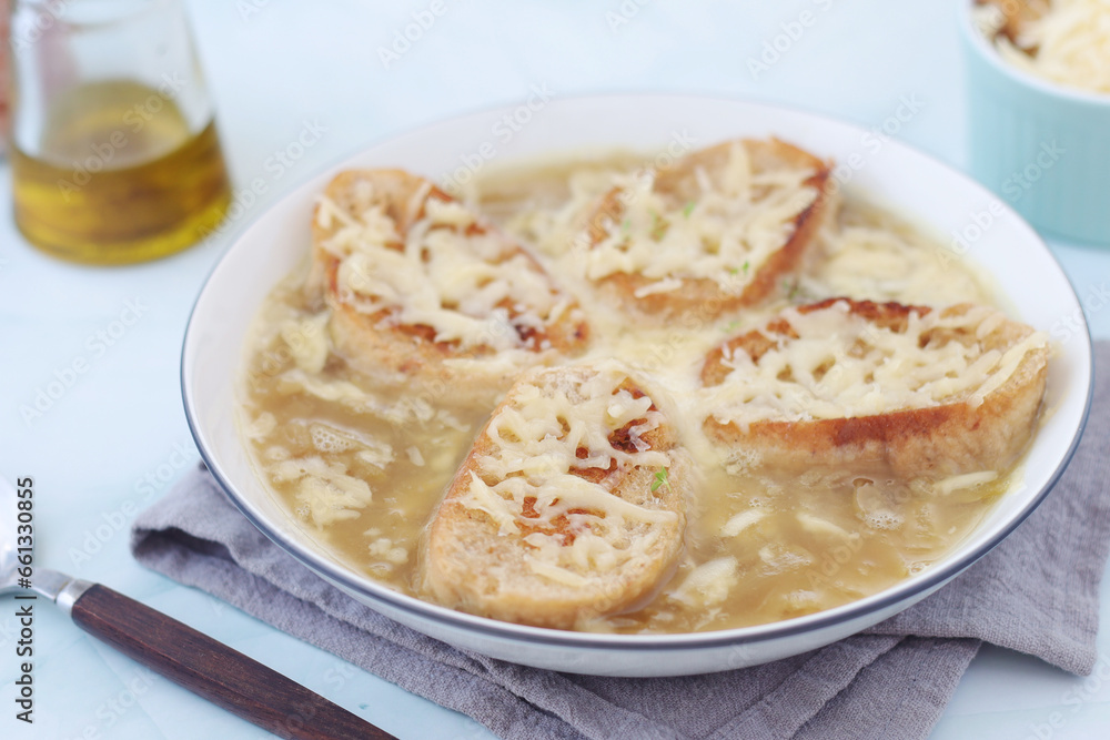 A ceramic bowl with French onion soup A ceramic bowl with French onion soup