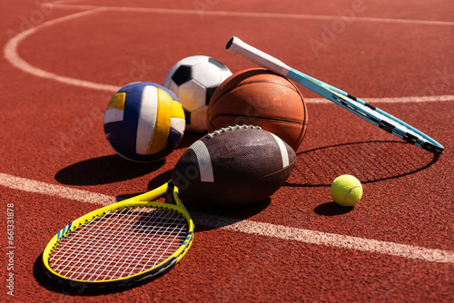 Fotografie A variety of sports equipment including an american football, a soccer ball, a t