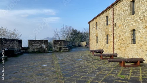 Video of the top of a fort with cannons on the side of a building photo