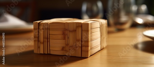 paper napkins in bamboo wood box on dining table photo