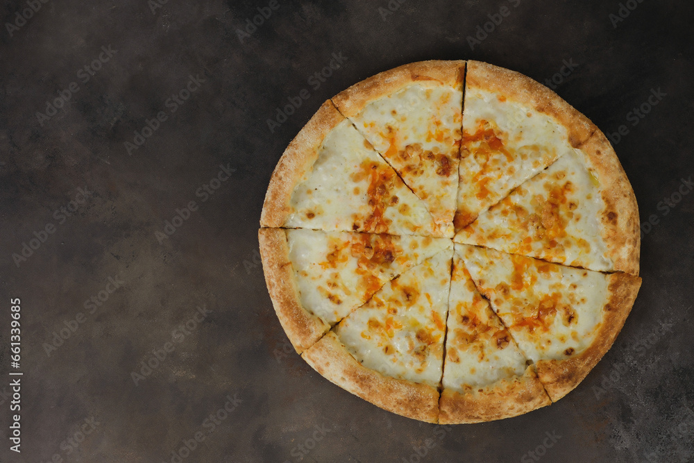 Slices of fresh round cheese on dark brown background, top view. Slices of fresh round cheese on dark brown background, top view.
