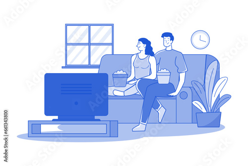 A couple watching tv in the living room