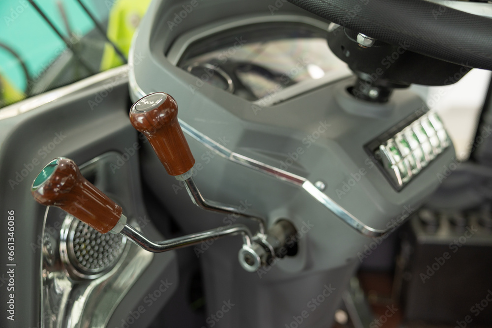 Fototapeta premium Steering wheel for forklift with ball rotating handle. Forklift handle - industrial background. Forklifts in a warehouse.