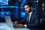 Young businessman or corporate employee using laptop at office.