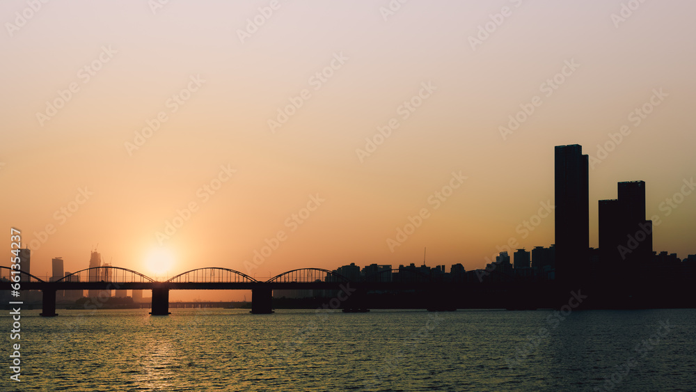 sunset with silhouette city and bridge background at seoul korea