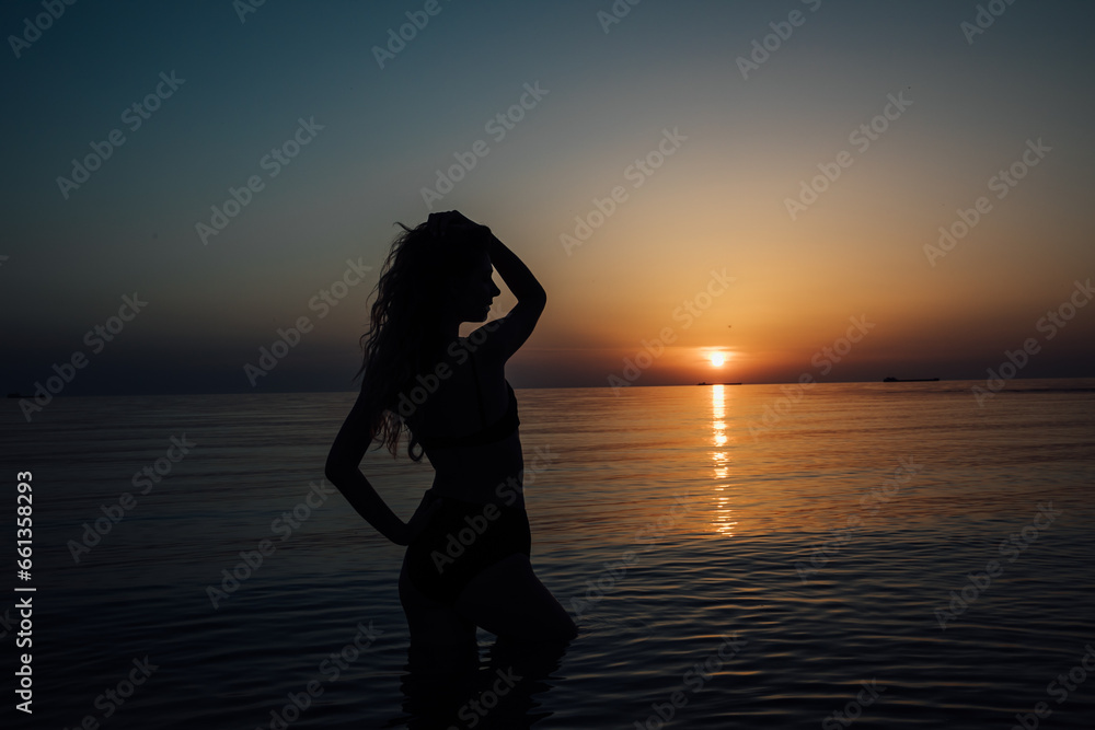 silhouette of a woman at sunset at sea rest beach walk travel