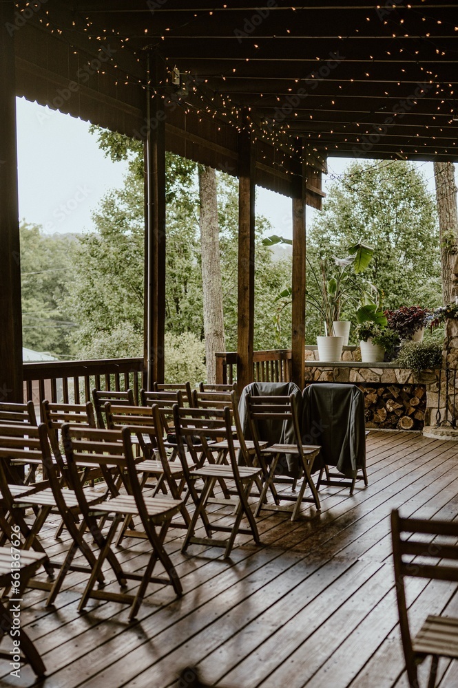 Picturesque outdoor wedding ceremony space with charming wooden chairs