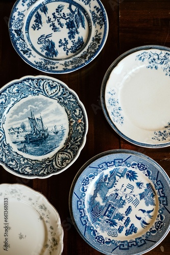 Antique wooden table in a rustic, vintage style, with a variety of blue china plates