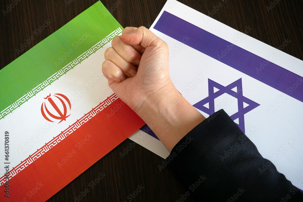 fingers-clenched-into-a-fist-against-the-background-of-the-flags-of
