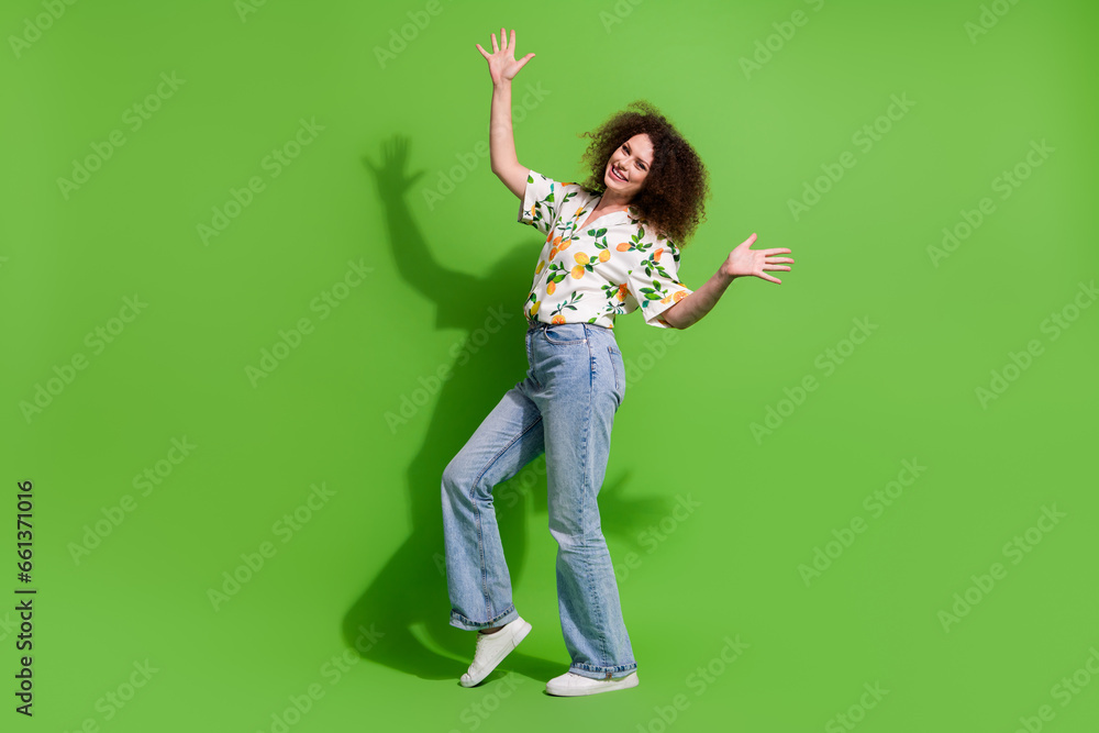Full length photo of cool cheerful girl dressed print shirt dancing discotheque empty space isolated green color background Full length photo of cool cheerful girl dressed print shirt dancing discotheque empty space isolated green color background