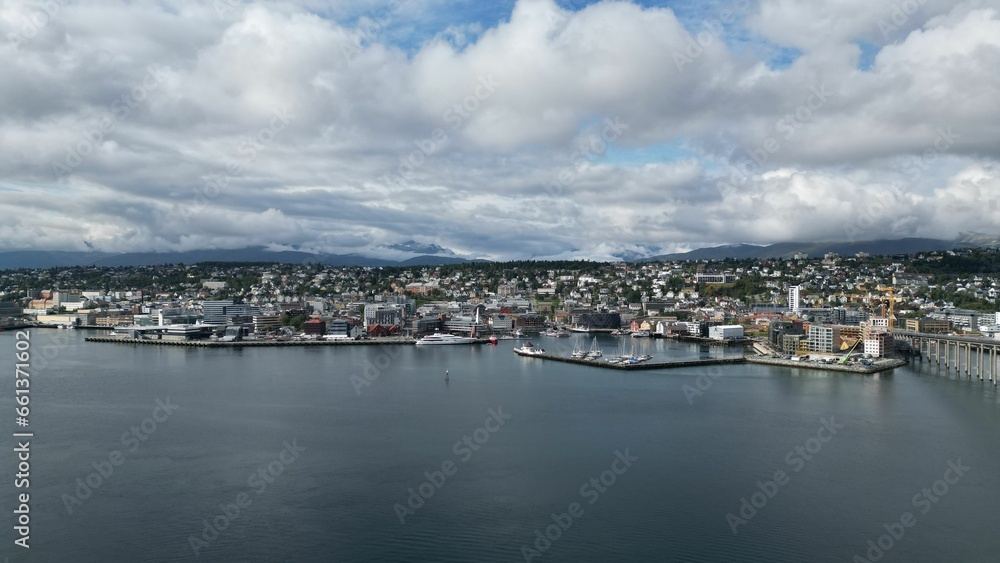 Aerial view of the boats moored along the shoreline in Tromso, Norway against the cityscape