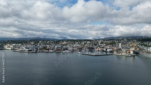 Aerial view of the boats moored along the shoreline in Tromso, Norway against the cityscape