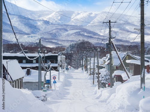 Townscape with heavy snowfall, snowy montains behind (Niseko, Hokkaido, Japan)