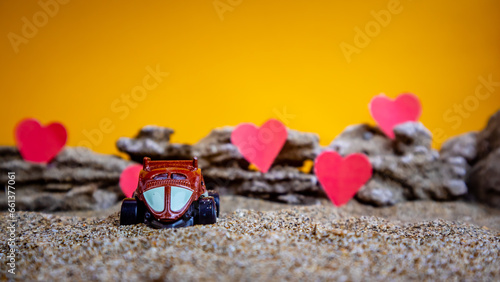 Minahasa  Indonesia - December 6  2022  toy car with gradient orange background and a heart