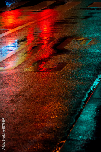 Neon light reflection onto rainy road by night, Tokyo, Japan