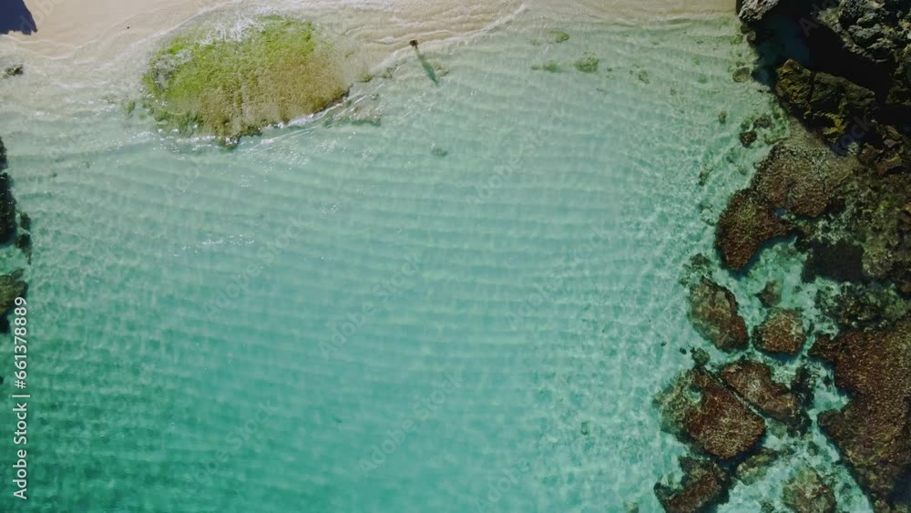 Aerial view over a person in Salmon Bay, Rottnest Island, Australia- ascending birds eye, drone shot Aerial view over a person in Salmon Bay, Rottnest Island, Australia- ascending birds eye, drone shot