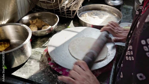 indian woman making chapati roti or indian wheat flatbread   photo