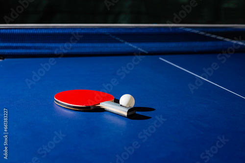 table tennis racket On the blue ping pong table