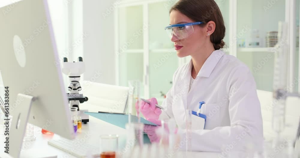 Scientist working at computer in laboratory. Medical chemical research Scientist working at computer in laboratory. Medical chemical research