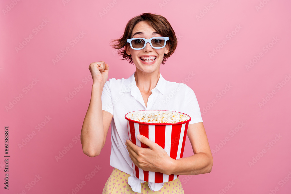 Portrait of overjoyed ecstatic woman wear stylish blouse in 3d glasses hold pop corn watch amazing movie isolated on pink color background Portrait of overjoyed ecstatic woman wear stylish blouse in 3d glasses hold pop corn watch amazing movie isolated on pink color background