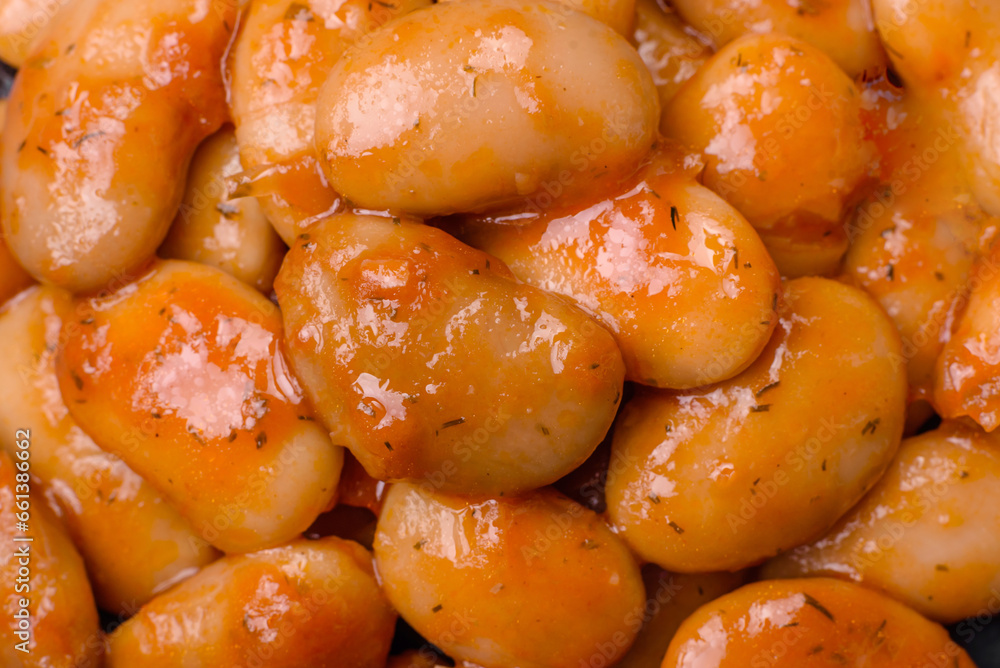 Delicious canned beans in a tomato in a round ceramic plate Delicious canned beans in a tomato in a round ceramic plate