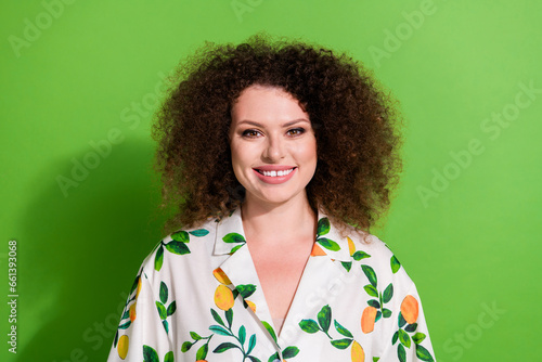 Portrait of gorgeous cheerful lady beaming smile good mood wavy hairdo isolated on green color background © deagreez