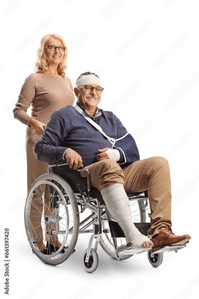 Woman standing behind injured man in a wheelchair Woman standing behind injured man in a wheelchair