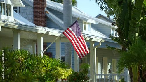 American national flag waving in front yard of Florida private house. Aerial view of USA stars and stripes spangled banner as symbol of democracy