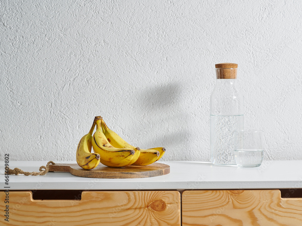 Yellow banana kitchen style, wooden table and water. Yellow banana kitchen style, wooden table and water.