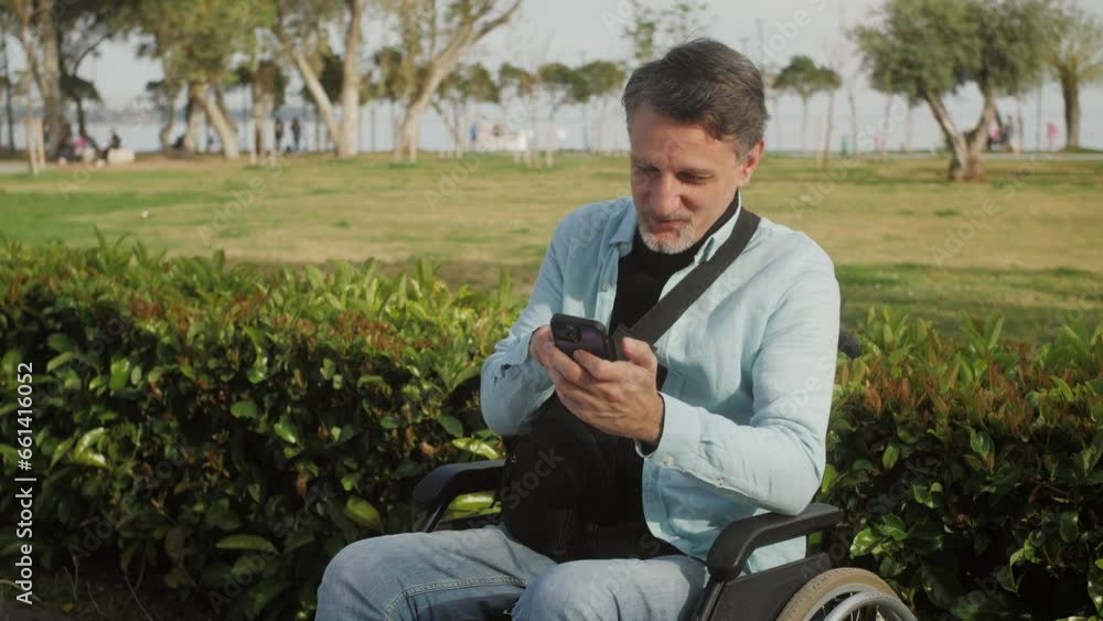 Arab Man sitting in a wheelchair while use mobile phone and credit card shopping online. Arab Man sitting in a wheelchair while use mobile phone and credit card shopping online.