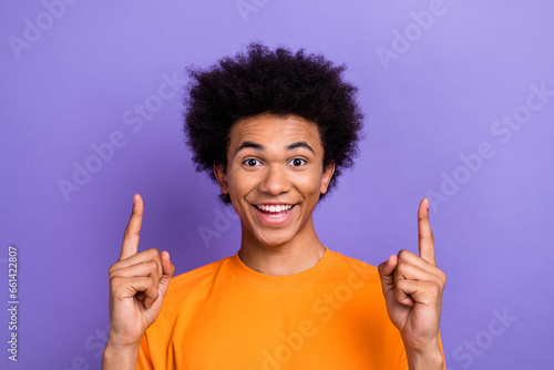 Portrait of cheerful funky person toothy smile indicate fingers up empty space proposition isolated on purple color background