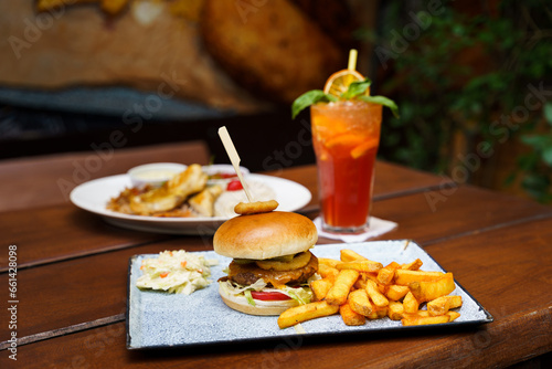 Hamburger with potatoes, onion ring, coleslaw and lemonade