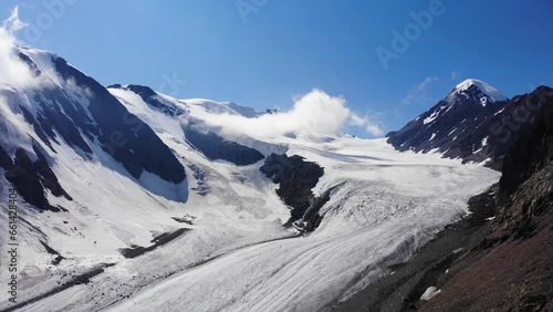 Top view of a large glacier and mountain peaks. 