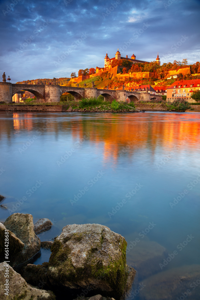 Wurzburg, Germany. Cityscape image of Wurzburg with Old Main Bridge over Main river and Marienberg Fortress during beautiful autumn sunrise.	
