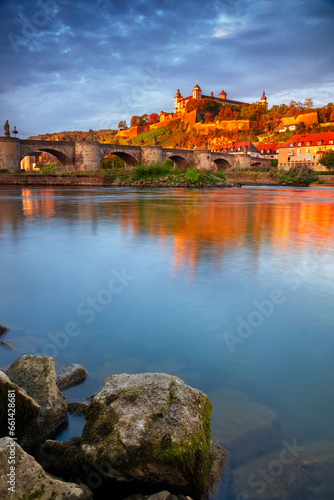 Wurzburg  Germany. Cityscape image of Wurzburg with Old Main Bridge over Main river and Marienberg Fortress during beautiful autumn sunrise.  