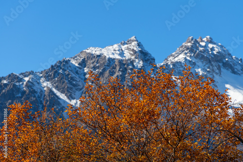 Snow-covered double-headed peak in the Trans-Ili Almaty mountains in the vicinity of Almaty on an autumn morning photo